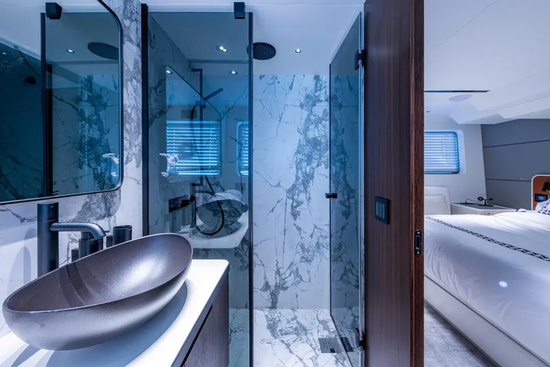 Alamar Yacht Photos Pics Luxurious 2023 Astondoa AS5 yacht bathroom with marble shower and modern sink design.