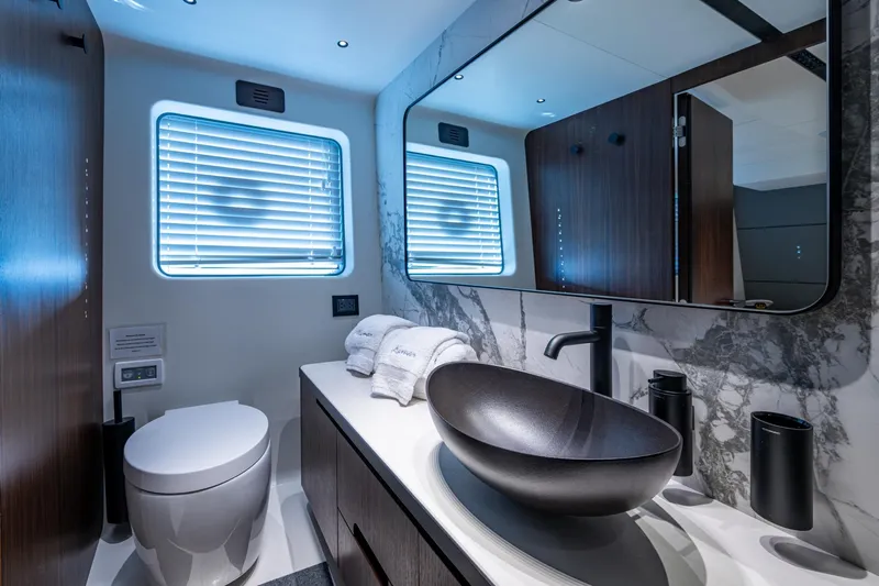 Alamar Yacht Photos Pics Luxurious bathroom in 2023 Astondoa AS5 yacht with modern fixtures and elegant design.