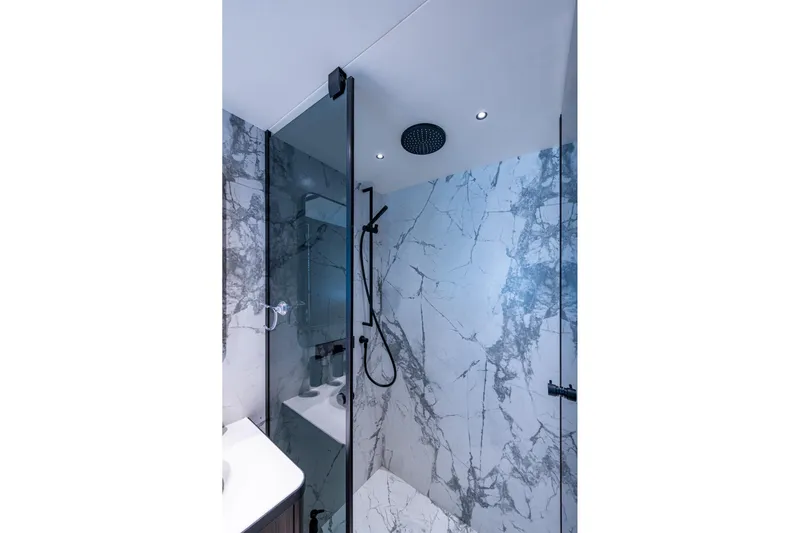 Alamar Yacht Photos Pics Luxurious marble shower in 2023 Astondoa AS5 yacht bathroom.