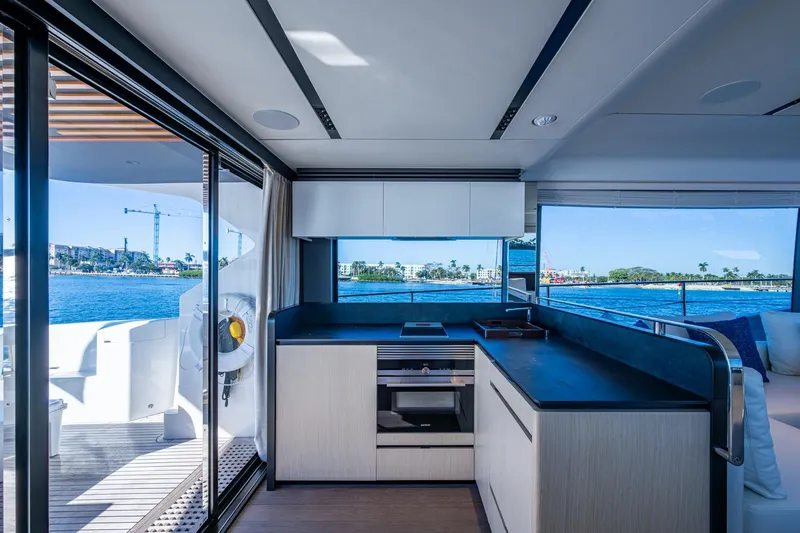 Alamar Yacht Photos Pics Luxurious interior of 2023 Astondoa AS5 yacht with modern kitchen and ocean view.
