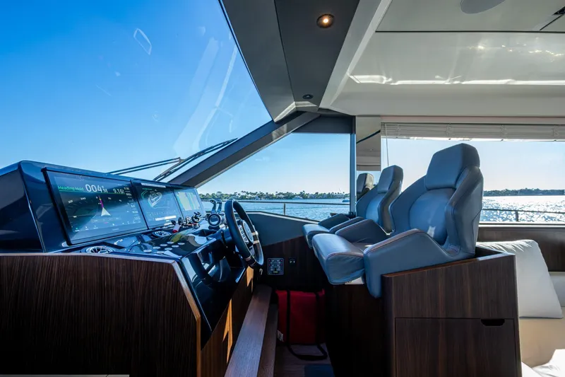Alamar Yacht Photos Pics 2023 Astondoa AS5 yacht helm with modern controls and luxurious seating.