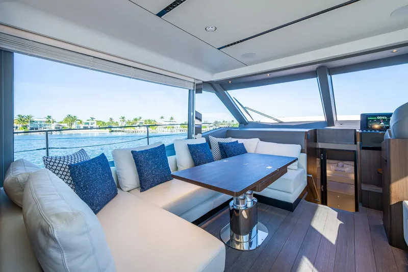 Alamar Yacht Photos Pics Luxurious interior of 2023 Astondoa AS5 yacht with elegant seating and scenic water view.
