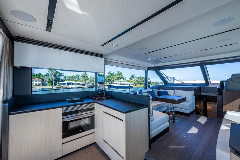 Alamar Yacht Photos Pics Luxurious interior of 2023 Astondoa AS5 yacht with modern kitchen and seating area.