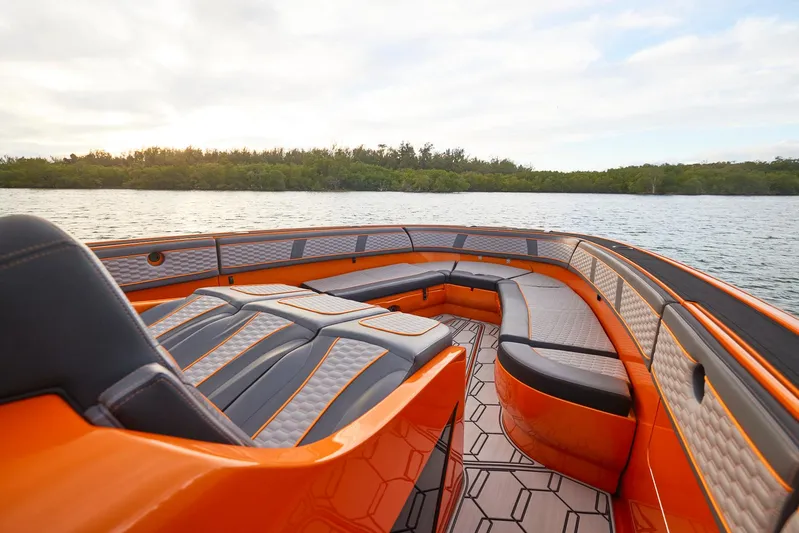  Yacht Photos Pics 2023 Midnight Express 43' Solstice boat with orange and black seating on a calm lake.