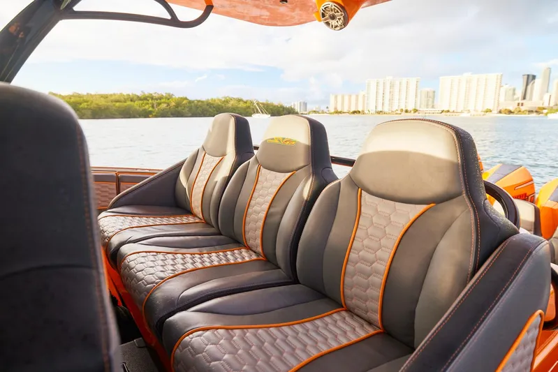  Yacht Photos Pics Luxurious seating on 2023 Midnight Express 43' Solstice boat, with waterfront cityscape in background.