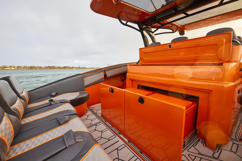  Yacht Photos Pics 2023 Midnight Express 43' Solstice boat interior with orange and gray seating, open storage.