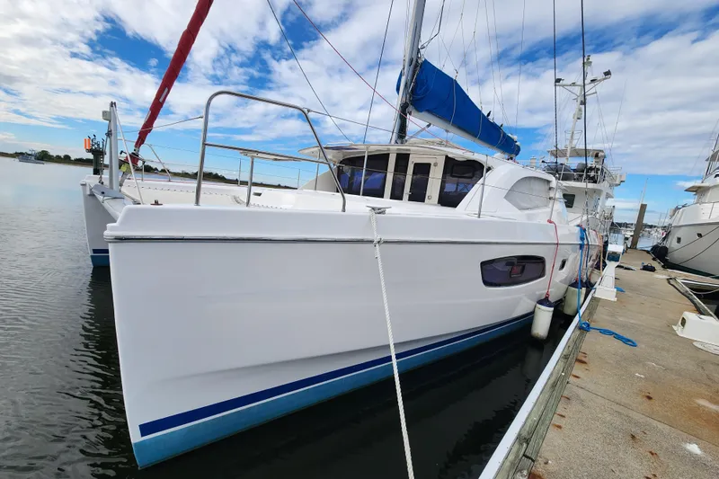 Cara Lynn Yacht Photos Pics 2015 Leopard 44 catamaran docked at marina under blue sky.