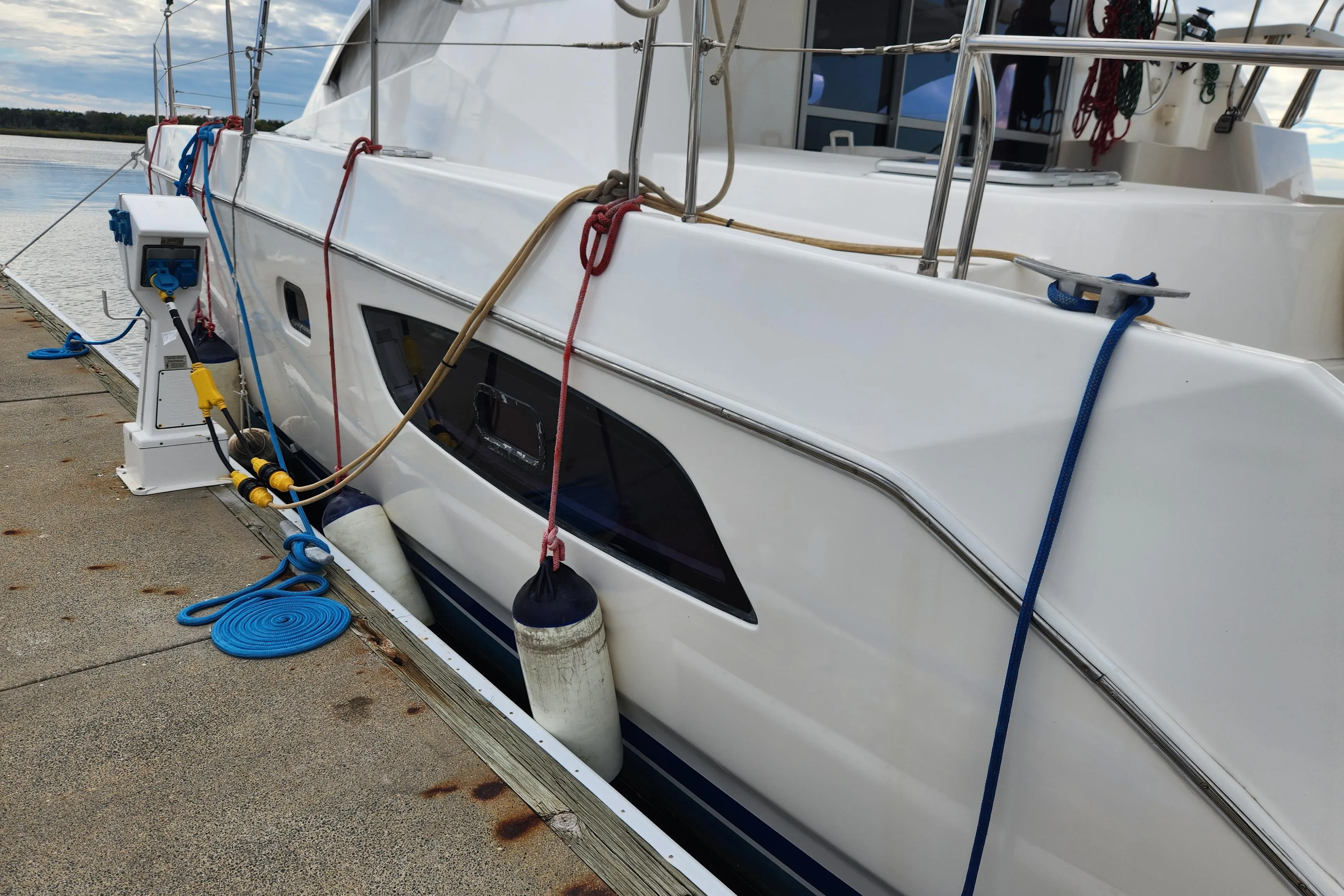 Leopard 44 catamaran docked, showing side view with ropes and fenders, 2015 model.