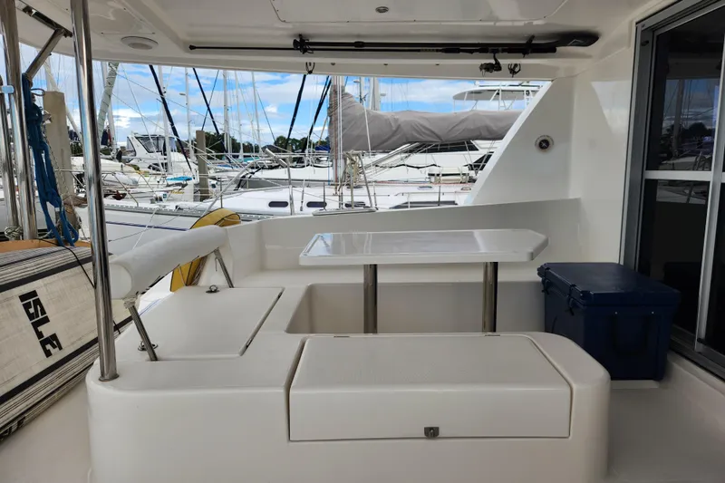 Cara Lynn Yacht Photos Pics Leopard 44 catamaran cockpit with seating and table, docked at marina, 2015 model.