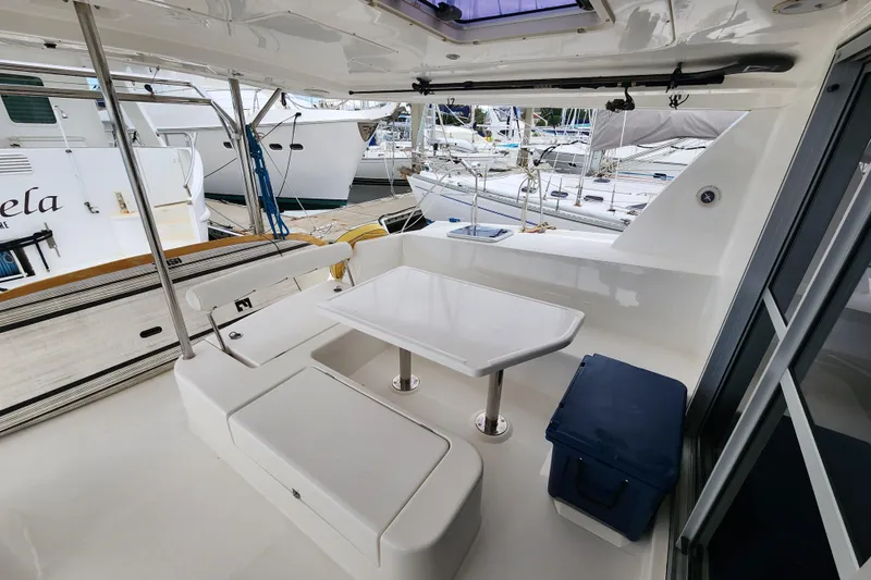 Cara Lynn Yacht Photos Pics Leopard 44 catamaran cockpit with seating and table, docked at marina, 2015 model.