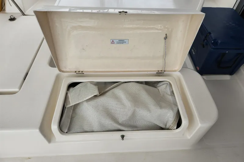 Cara Lynn Yacht Photos Pics Open storage compartment on 2015 Leopard 44 boat, containing a folded sail.