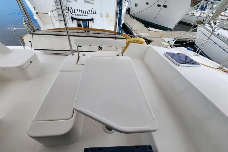 Cara Lynn Yacht Photos Pics Spacious deck area of a 2015 Leopard 44 catamaran with seating and table.