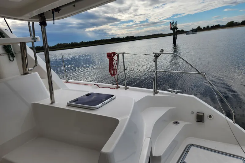 Cara Lynn Yacht Photos Pics 2015 Leopard 44 yacht deck overlooking calm waters and cloudy sky.