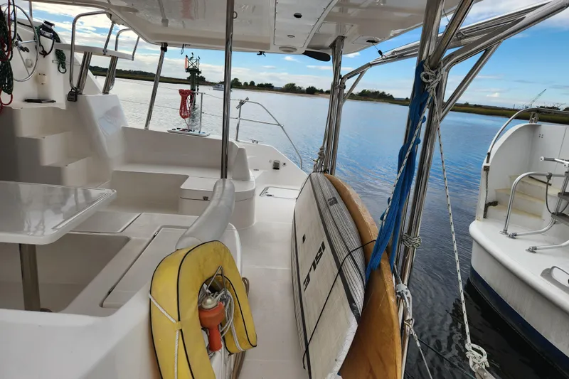 Cara Lynn Yacht Photos Pics Leopard 44 catamaran interior with surfboard, docked on calm water, 2015 model.