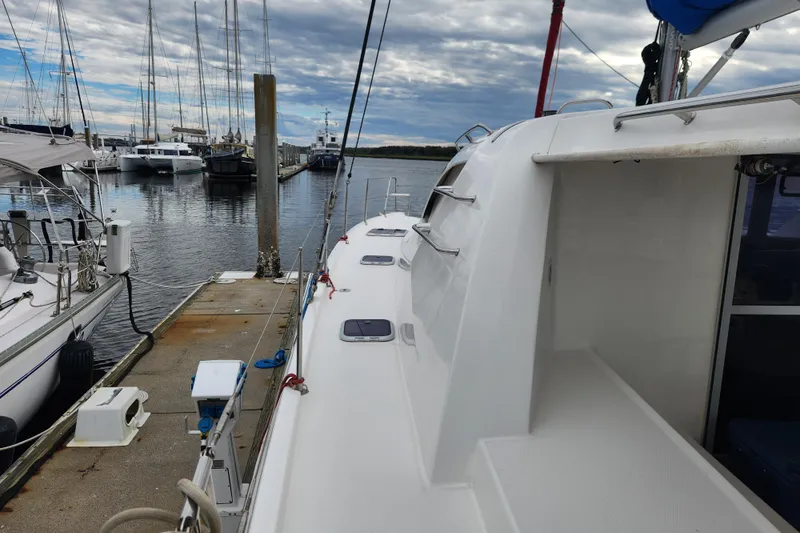 Cara Lynn Yacht Photos Pics 2015 Leopard 44 catamaran docked at marina with cloudy sky backdrop.