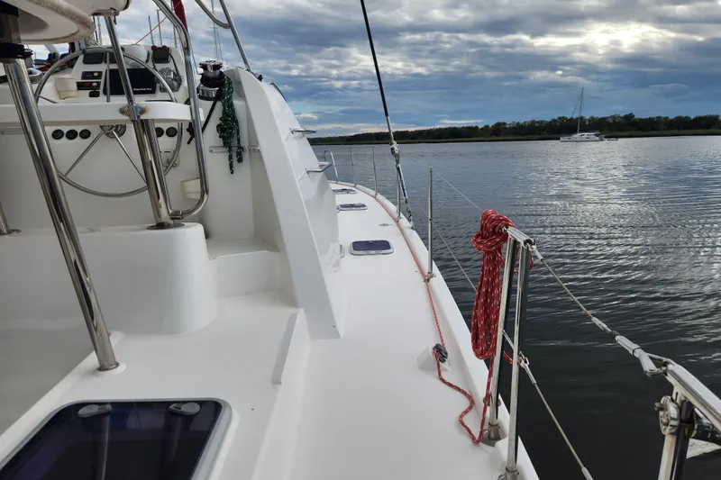 Cara Lynn Yacht Photos Pics Sailing yacht Leopard 44, 2015 model, on calm waters under a cloudy sky.