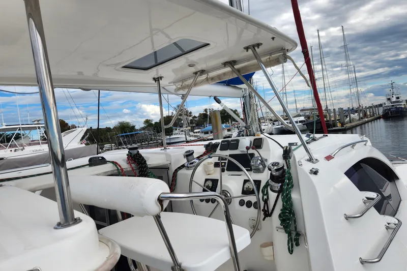 Cara Lynn Yacht Photos Pics Cockpit view of a 2015 Leopard 44 catamaran docked at a marina.