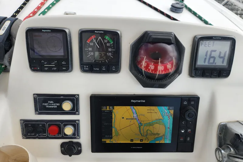 Cara Lynn Yacht Photos Pics Control panel of a 2015 Leopard 44 yacht with navigation instruments and depth display.