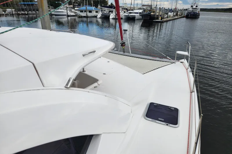 Cara Lynn Yacht Photos Pics 2015 Leopard 44 catamaran docked at marina, showcasing sleek design and spacious deck.
