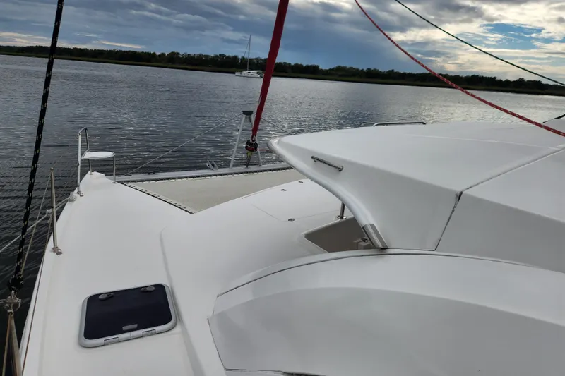 Cara Lynn Yacht Photos Pics 2015 Leopard 44 catamaran on calm water under cloudy sky.