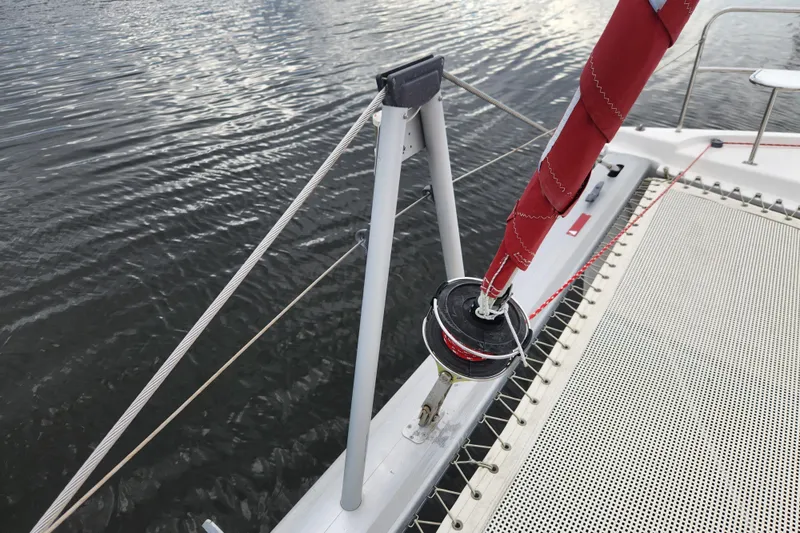 Cara Lynn Yacht Photos Pics 2015 Leopard 44 sailboat deck with red sail and rigging on calm water.