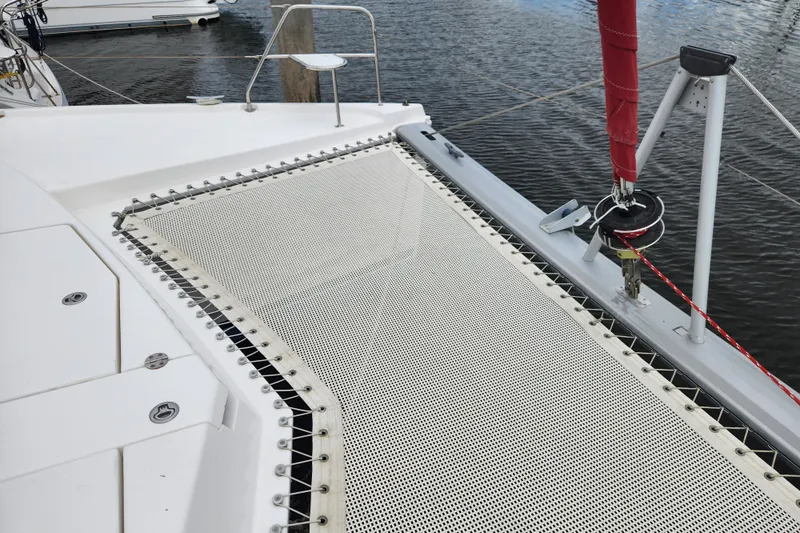 Cara Lynn Yacht Photos Pics 2015 Leopard 44 catamaran with netting and rigging details, docked on calm water.