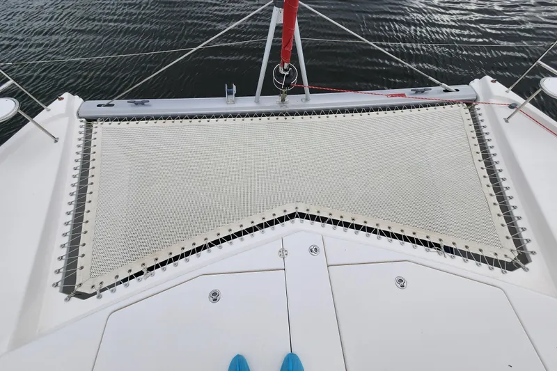 Cara Lynn Yacht Photos Pics Front deck of a 2015 Leopard 44 catamaran with netting over water.