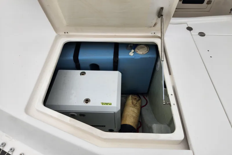 Cara Lynn Yacht Photos Pics Open storage compartment on 2015 Leopard 44 boat, showing equipment and blue tank.