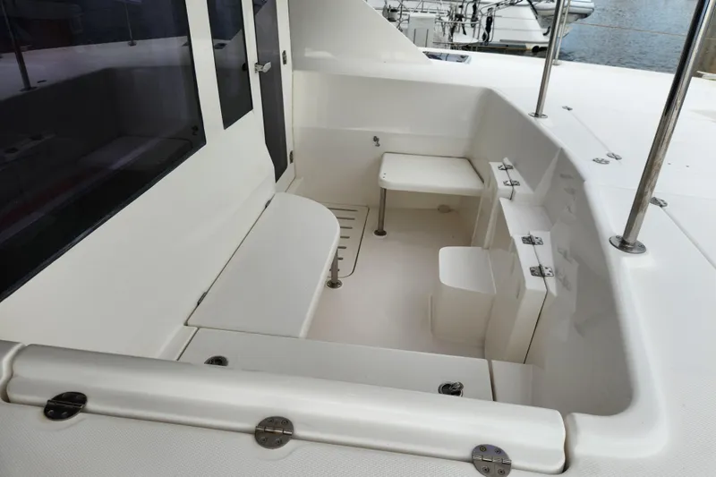 Cara Lynn Yacht Photos Pics 2015 Leopard 44 yacht cockpit with seating and table, featuring sleek white design.