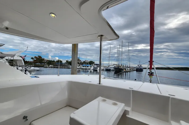 Cara Lynn Yacht Photos Pics 2015 Leopard 44 yacht interior with marina view, showcasing sleek design and spacious seating.