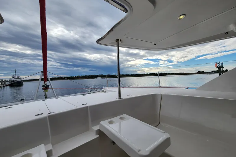Cara Lynn Yacht Photos Pics 2015 Leopard 44 catamaran deck view with serene waters and cloudy sky.