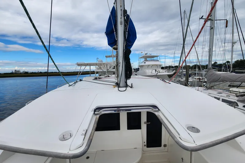 Cara Lynn Yacht Photos Pics 2015 Leopard 44 catamaran docked at marina under cloudy sky.
