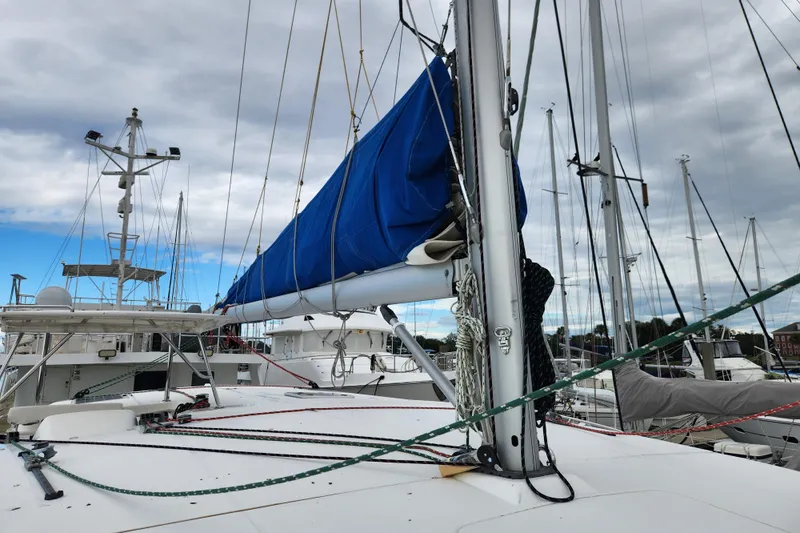 Cara Lynn Yacht Photos Pics Sailboat deck view of 2015 Leopard 44 with blue sail cover in marina.