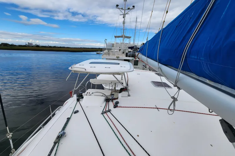 Cara Lynn Yacht Photos Pics Sailing catamaran Leopard 44, 2015 model, docked with blue sail cover, calm waters.