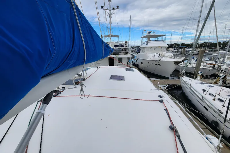 Cara Lynn Yacht Photos Pics 2015 Leopard 44 catamaran docked at marina, surrounded by other boats.