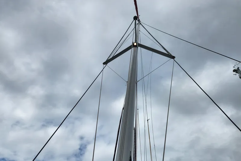 Cara Lynn Yacht Photos Pics Mast of 2015 Leopard 44 sailboat against cloudy sky.