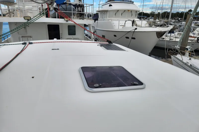 Cara Lynn Yacht Photos Pics 2015 Leopard 44 yacht deck with hatch, docked in a marina.