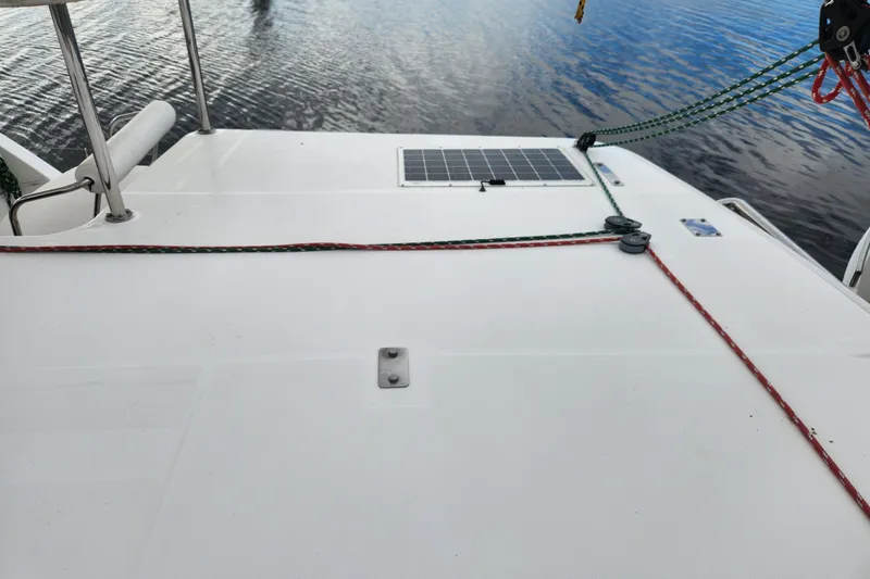 Cara Lynn Yacht Photos Pics Deck of 2015 Leopard 44 catamaran with solar panel and ropes on calm water.