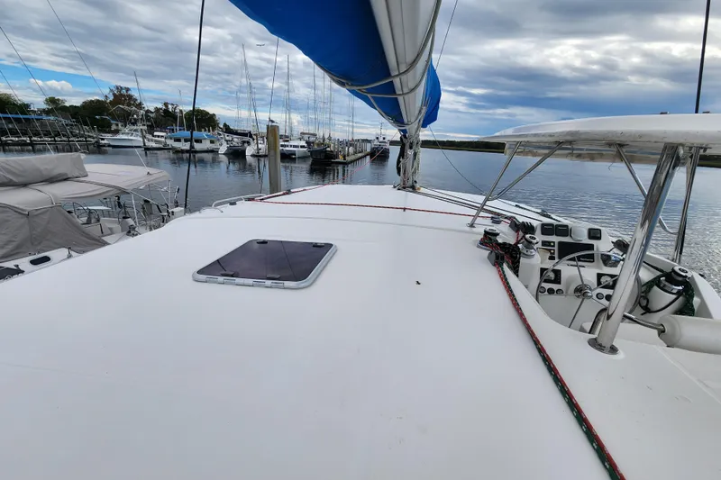 Cara Lynn Yacht Photos Pics 2015 Leopard 44 catamaran docked at marina, featuring spacious deck and blue sail.