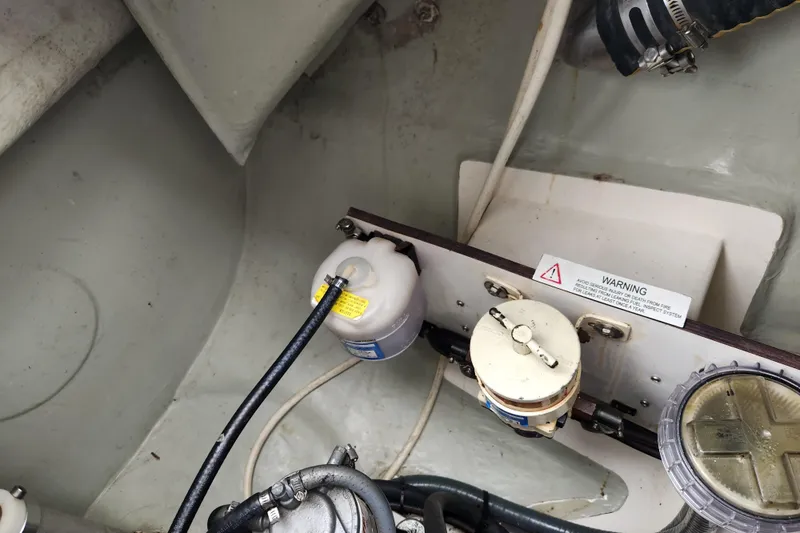 Cara Lynn Yacht Photos Pics Engine compartment of a 2015 Leopard 44 with fluid reservoirs and warning label.