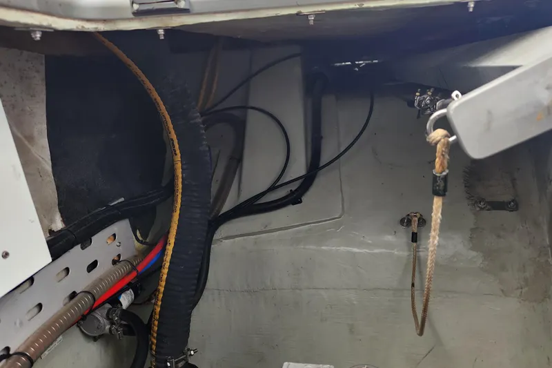 Cara Lynn Yacht Photos Pics Engine compartment of a 2015 Leopard 44 boat, showing cables and hoses.