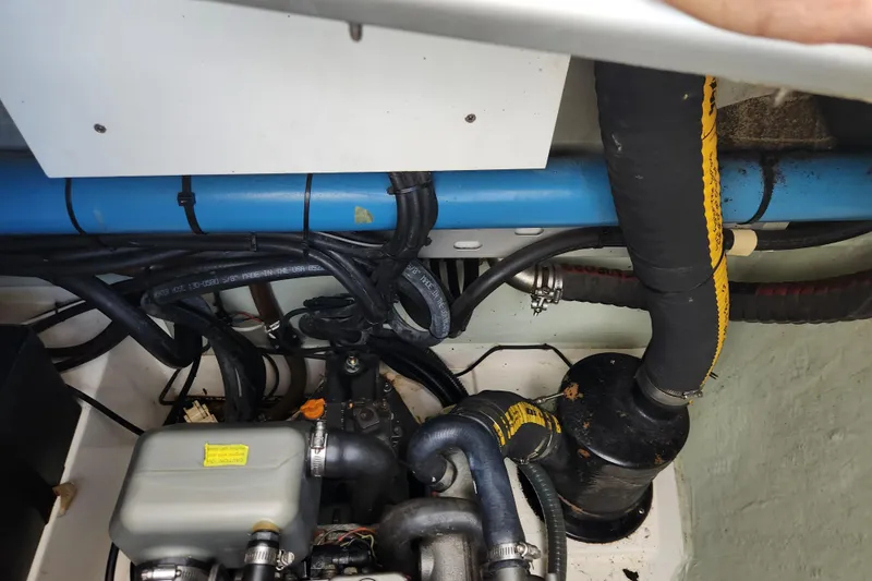 Cara Lynn Yacht Photos Pics Engine compartment of a 2015 Leopard 44, showcasing hoses and mechanical components.