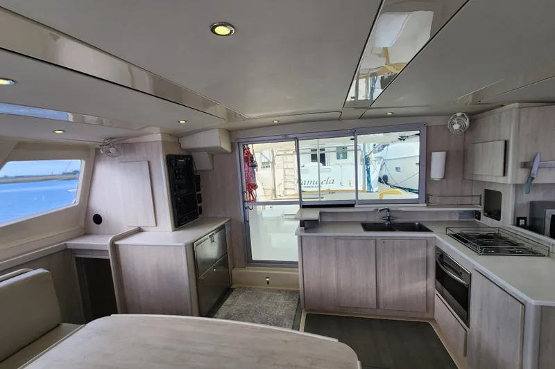 Cara Lynn Yacht Photos Pics Modern kitchen interior of a 2015 Leopard 44 yacht with sleek cabinetry and appliances.