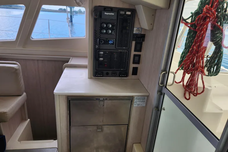 Cara Lynn Yacht Photos Pics Interior of a 2015 Leopard 44 yacht with control panel and ropes.