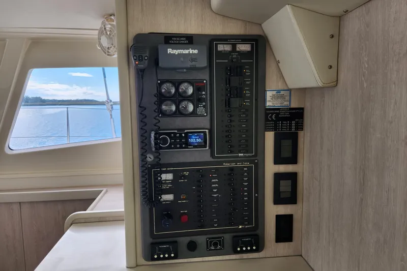 Cara Lynn Yacht Photos Pics Control panel inside a 2015 Leopard 44 yacht, featuring navigation and communication equipment.