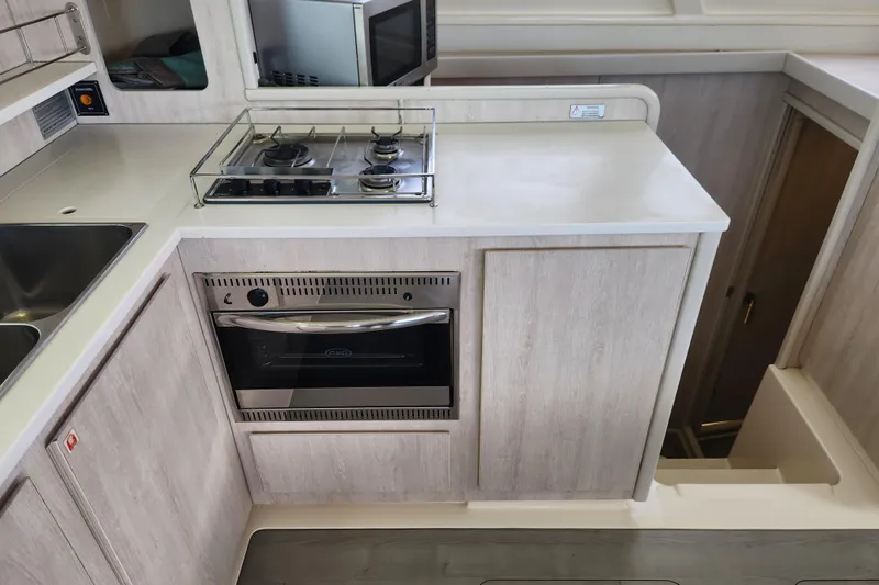 Cara Lynn Yacht Photos Pics Modern kitchen in a 2015 Leopard 44 yacht with stove and oven.