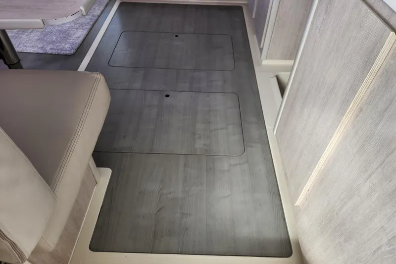 Cara Lynn Yacht Photos Pics Interior of 2015 Leopard 44 yacht with sleek wooden flooring and seating area.