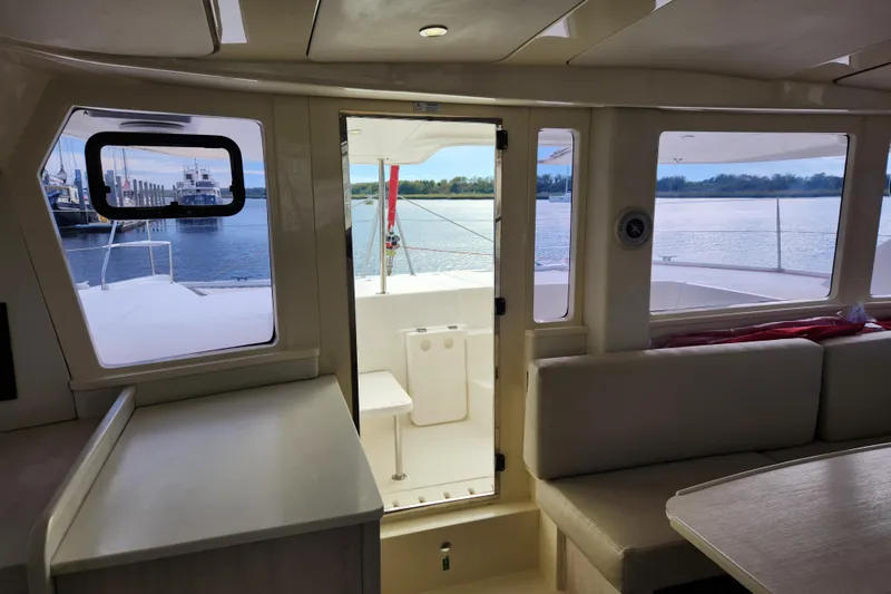 Cara Lynn Yacht Photos Pics Interior view of 2015 Leopard 44 catamaran with water and dock visible through windows.