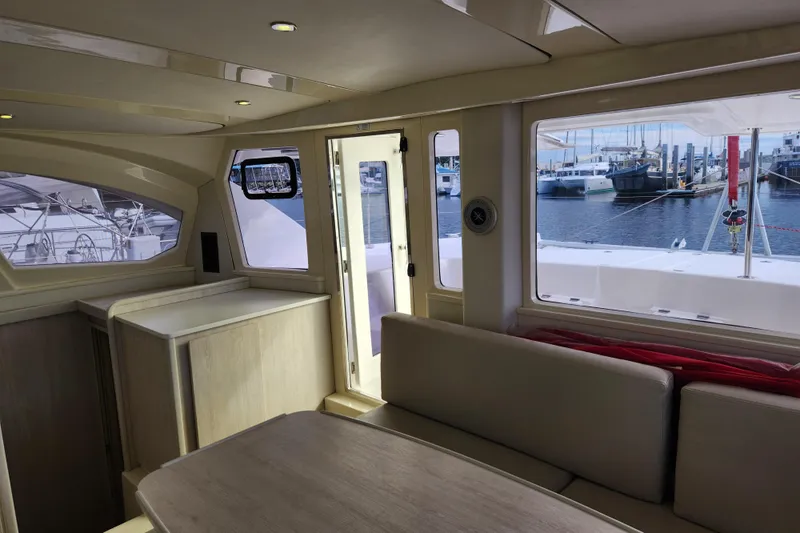 Cara Lynn Yacht Photos Pics Interior of 2015 Leopard 44 catamaran with marina view through large windows.