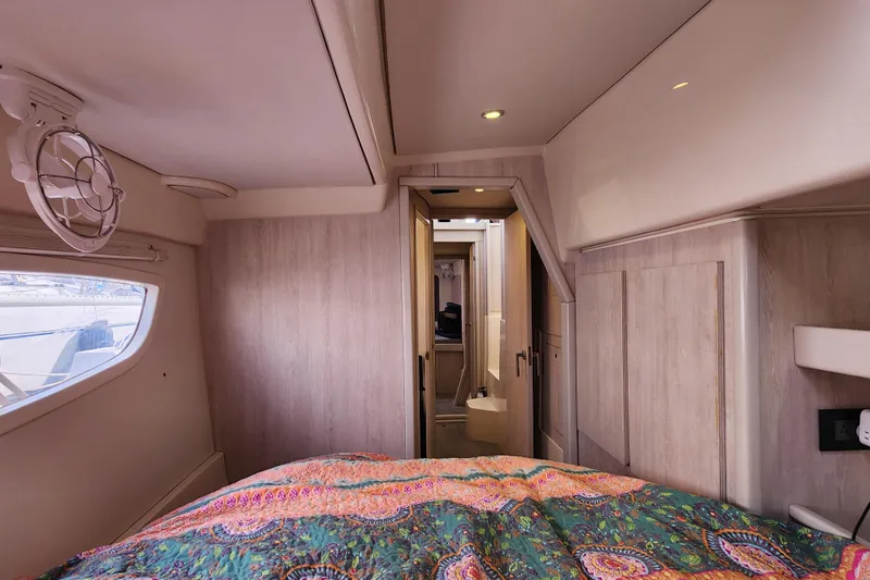 Cara Lynn Yacht Photos Pics Interior of 2015 Leopard 44 yacht cabin with colorful bedding and modern design.